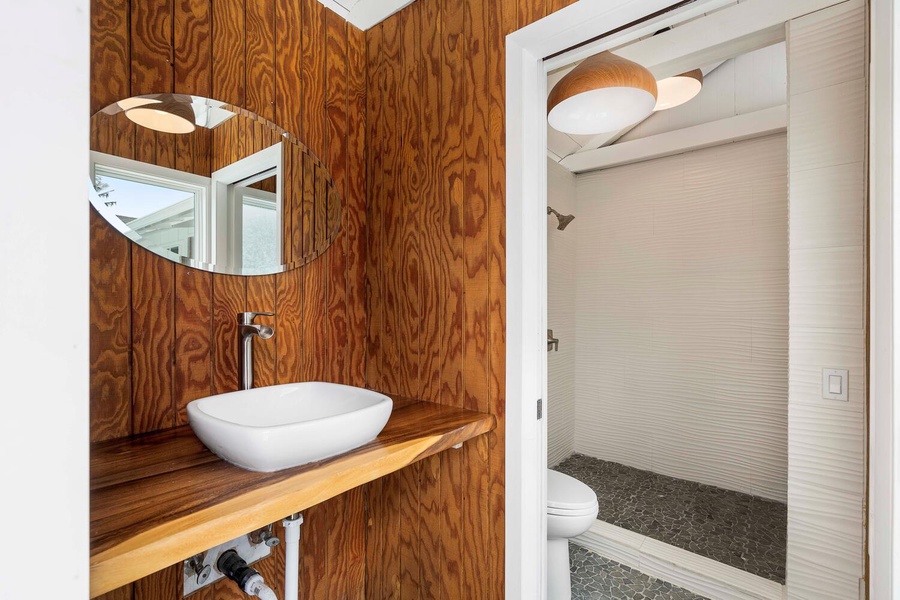 The cabana bathroom with a single vanity near the pool.