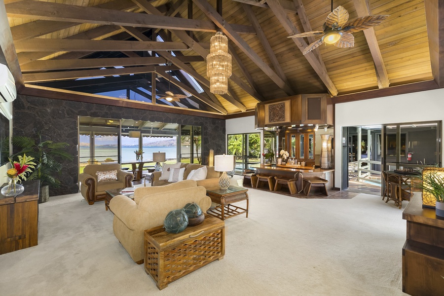 Large living room with ocean views that opens up to pool and oceanfront yard.