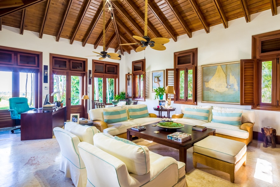 Relax in the living area with high, vaulted ceilings and seamless access to the garden.