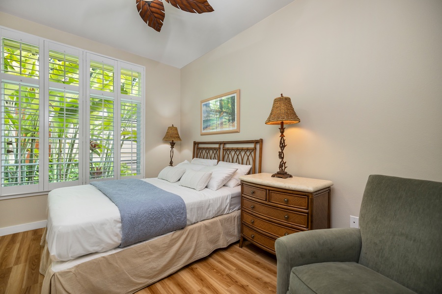 Wake up to serene views in a cozy second guest bedroom featuring natural light and thoughtful touches.