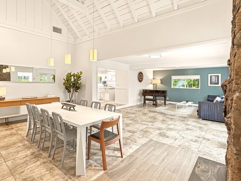 The spacious open-plan living unfolds with soaring ceilings and natural light streaming through windows, creating an airy retreat for memorable gatherings.