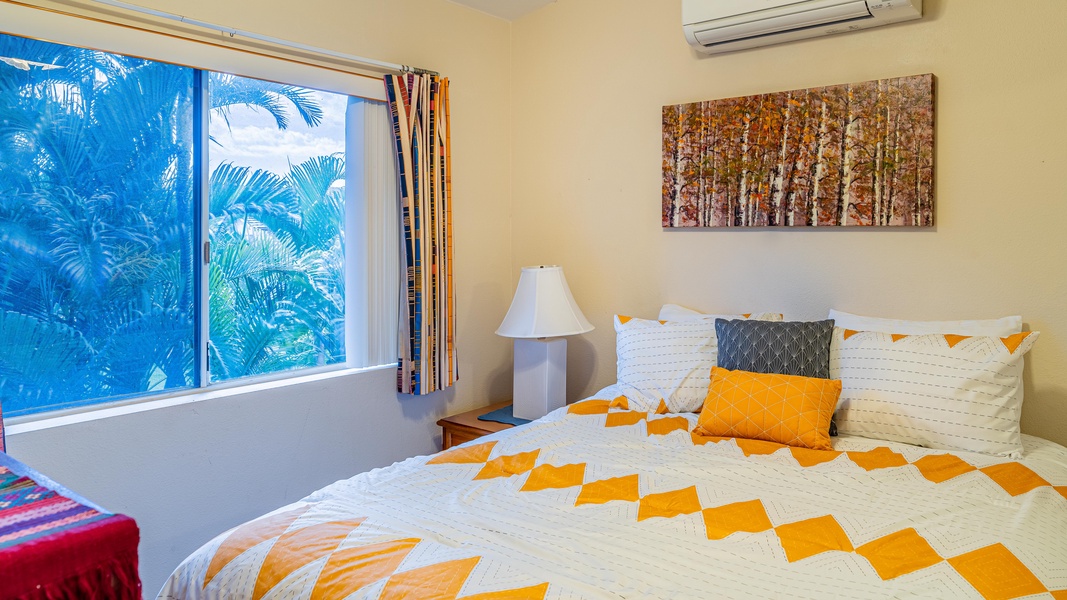 The third guest bedroom offers a view and bright patterns.