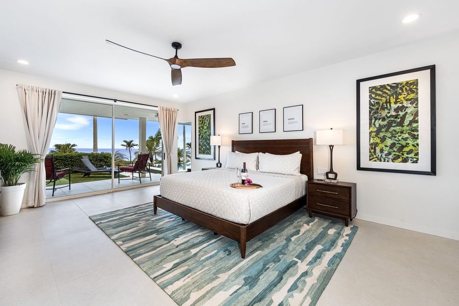 Wake up to ocean views from the primary suite, complete with private lanai access, soft lighting, and tropical-inspired décor.