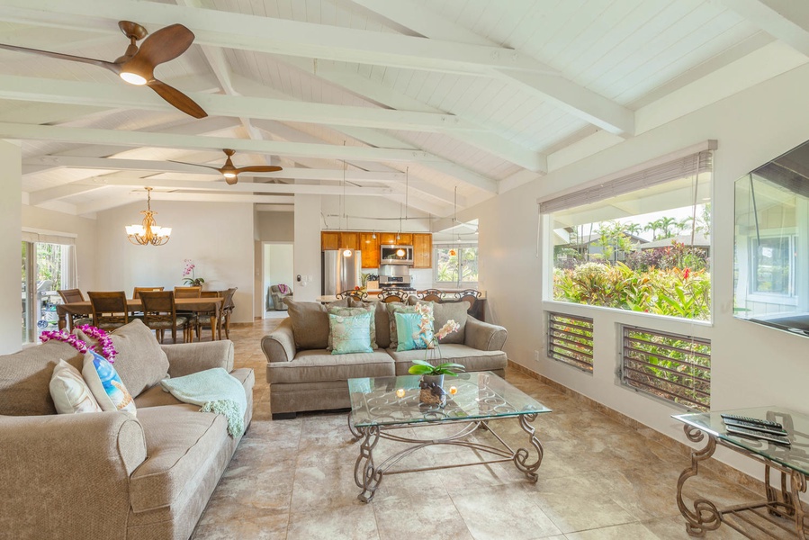 The stylishly decorated living room features plush sofas and garden views