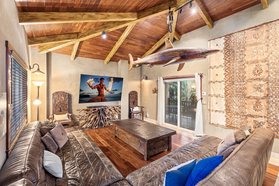 Rustic luxury media room with vaulted ceilings and a giant Smart TV—movie nights never looked so good.
