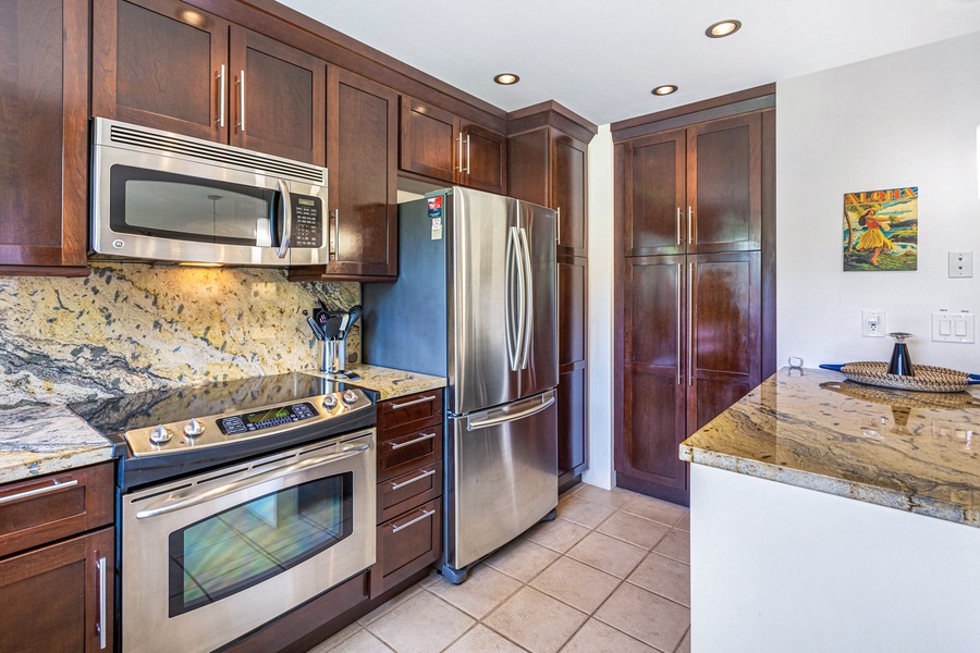 The kitchen offers modern stainless steel appliances and plenty of storage space, perfect for preparing meals during your stay.