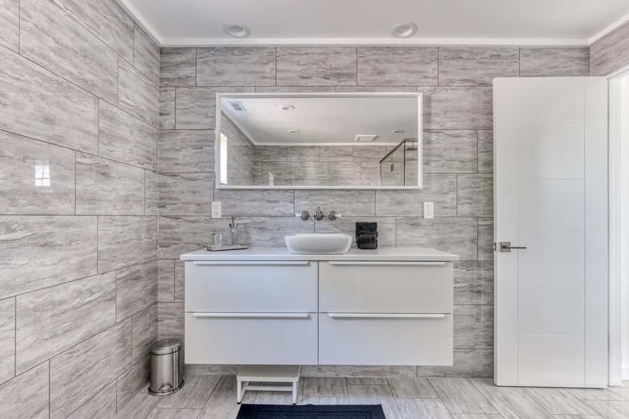 Fully tiled primary ensuite with large vanity and storage