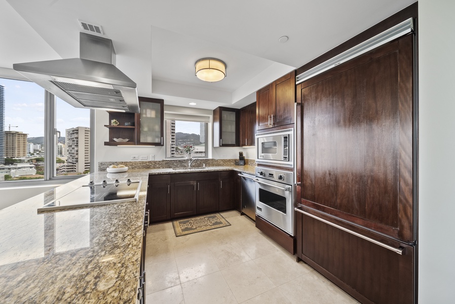 The modern designed kitchen has stainless steel appliances and plenty space to make meal prep convenient.
