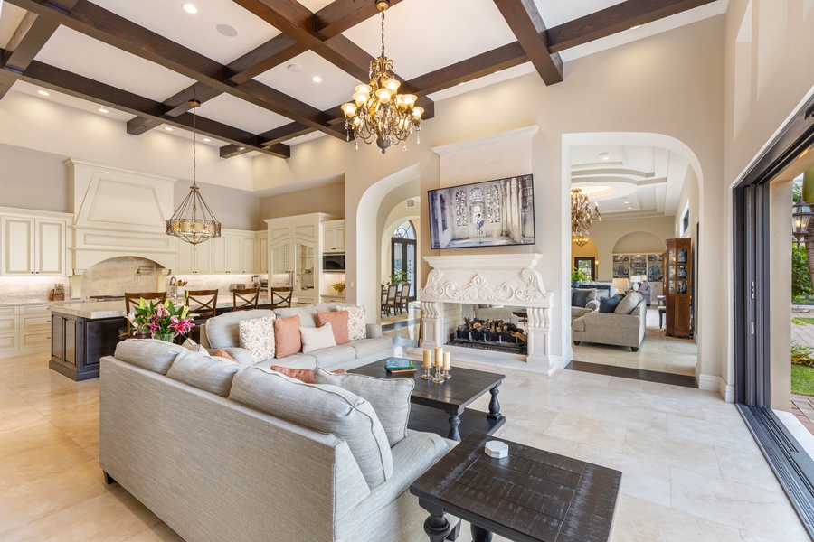 Elegant living room with a fireplace, high ceilings, and beautiful architectural details for a luxurious yet welcoming ambiance.