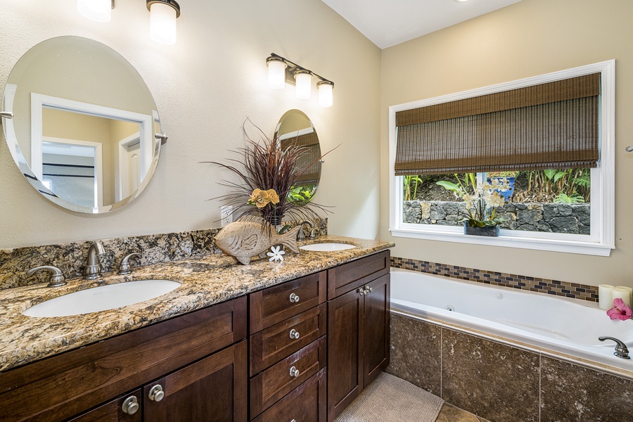 Spacious dual vanities in the primary en suite provide convenience and a spa-like experience.