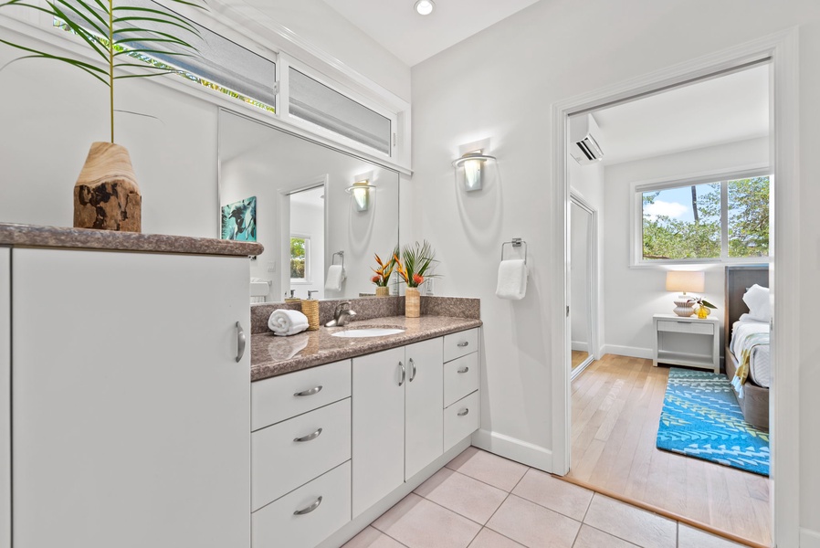 Shared Jack and Jill bath with double sinks and modern coastal style.