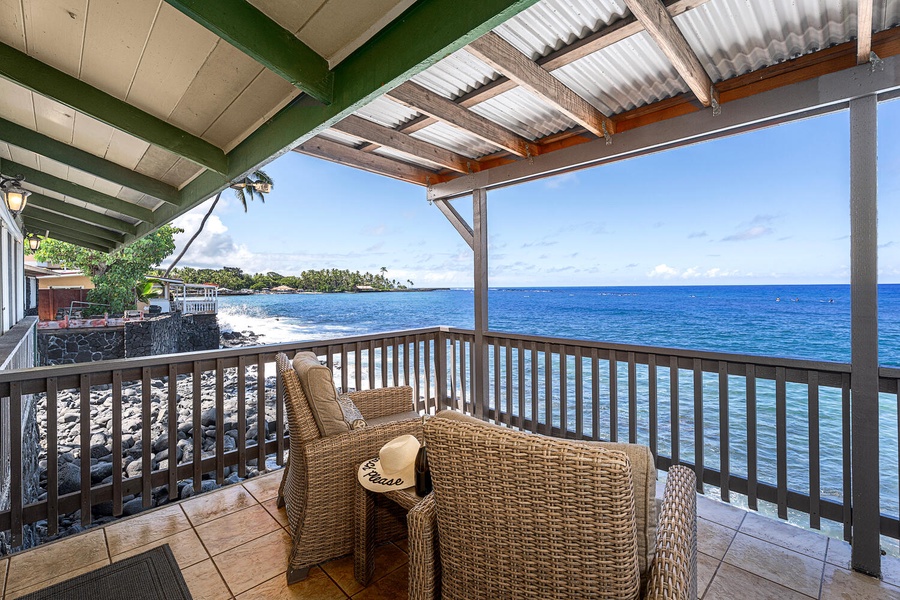 Spacious lanai with cozy seating, perfect for morning coffee or evening sunsets over the water.
