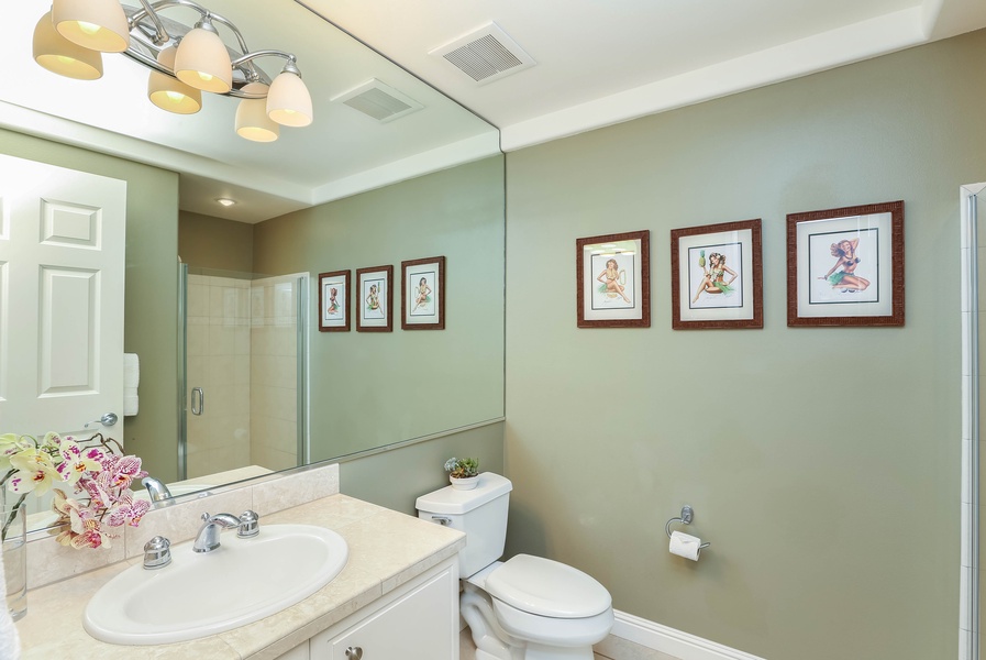 Guest hallway bathroom with a walk-in shower for convenience.