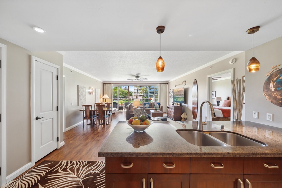Enjoy an expansive open-concept layout at Honua Kai Konea 204, where the kitchen flows effortlessly into the living and dining spaces.
