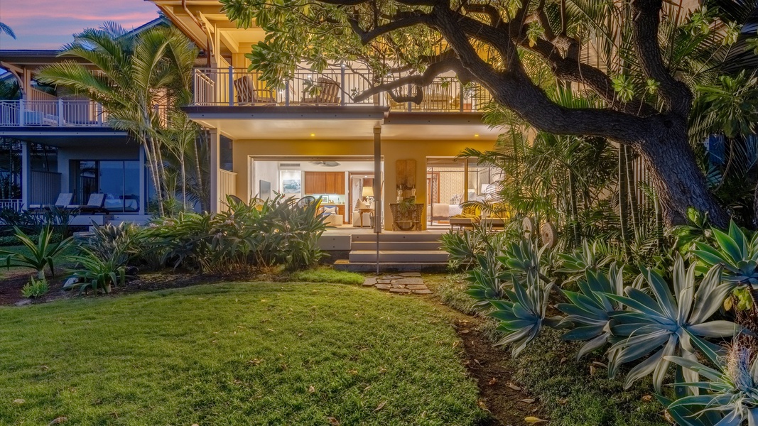Ground-level lanai opens to a lush green yard—perfect for relaxing.