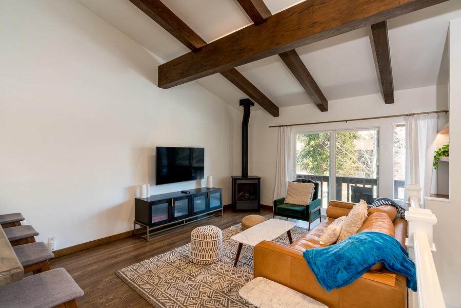 The lofted ceilings adorned with rustic beams add a touch of charm and character to the space
