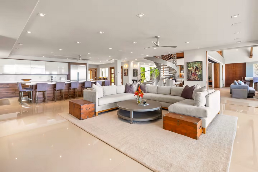 A second lounge under the wood beams, the sectional angled for long talks.