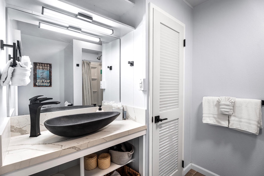 Contemporary bathroom with unique vessel sink and bright design.
