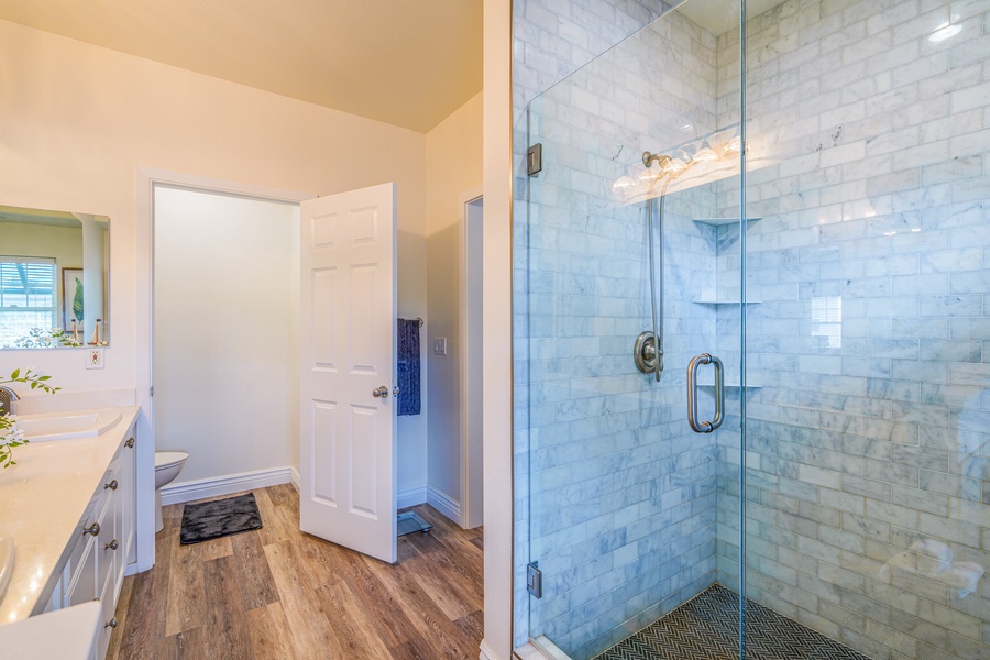 The en suite bathroom's  walk-in shower across the sink.