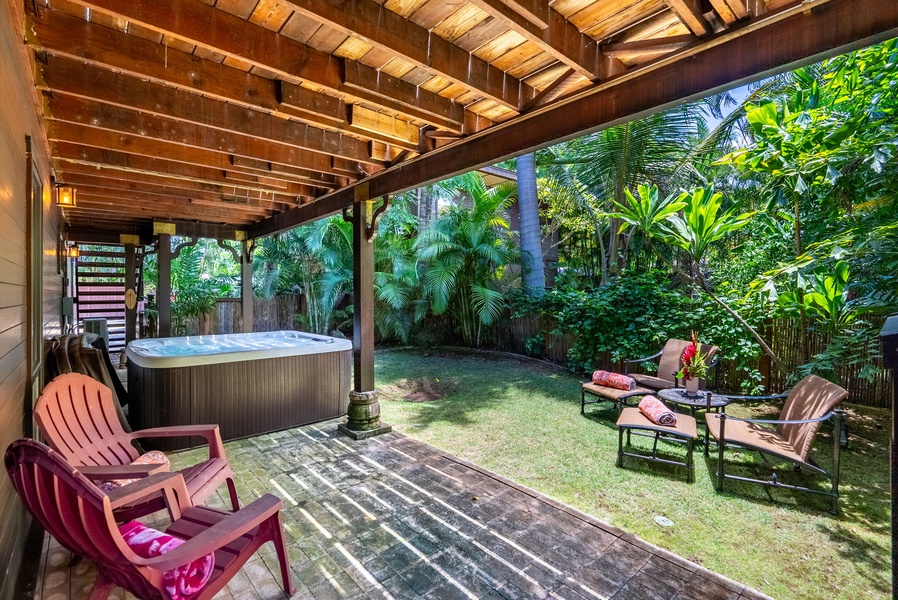 Relax outdoors featuring the hot tub with garden views.