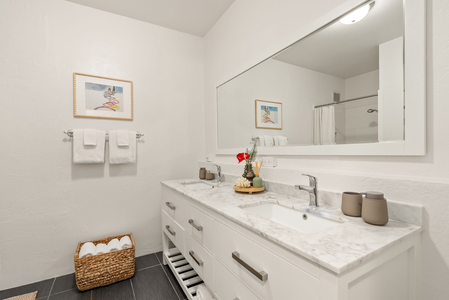 Refresh in your bright, modern bathroom with soft towels and thoughtful touches waiting on the marble vanity. Everything you need for a comfortable stay is right here.