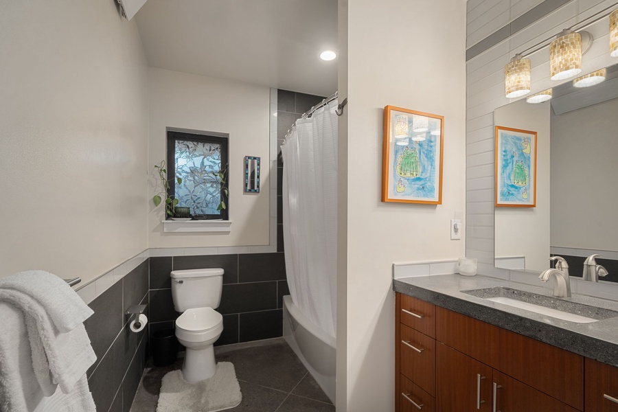 Step into your private spa-like bathroom with sleek fixtures, warm wood vanity, and thoughtful touches that make every morning feel luxurious.