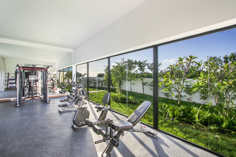 Stay fit in the well-equipped gym with floor-to-ceiling windows and garden views.
