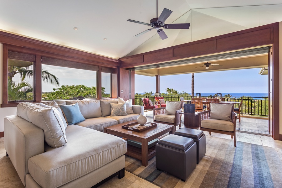 Abundant natural light and ocean views in the living area, with sliding glass pocket doors out to the lanai.