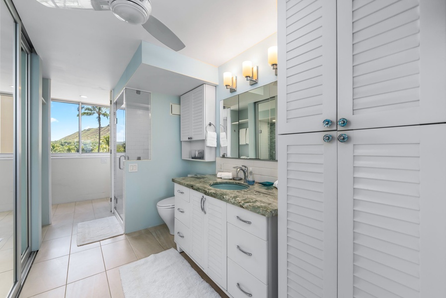 Modern bathroom with luxe double vanity, walk-in shower, and thoughtful storage—style meets functionality in paradise.