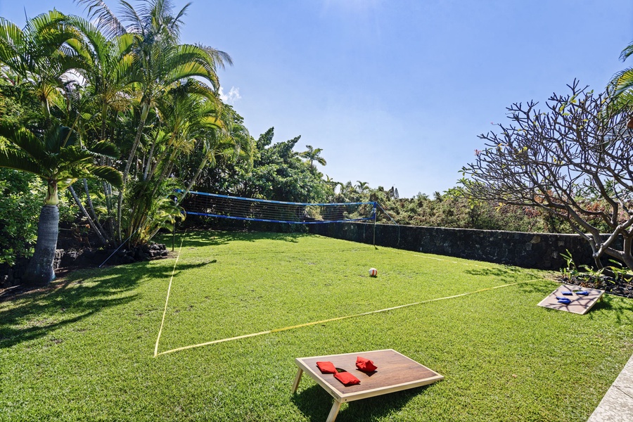 Private lawn area featuring a fun cornhole setup for endless outdoor entertainment.