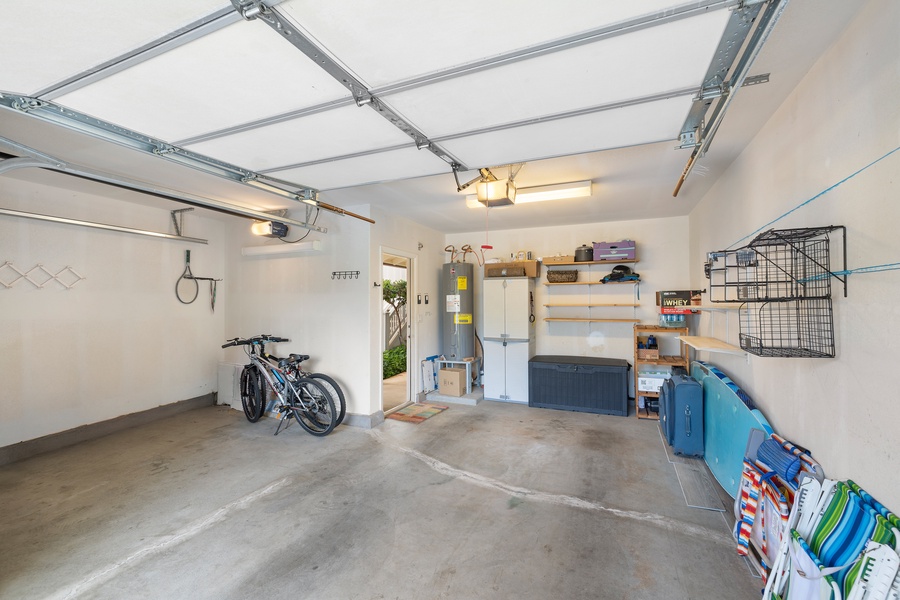 Spacious garage stocked with beach gear—perfect for surfboards, snorkels, or bikes.