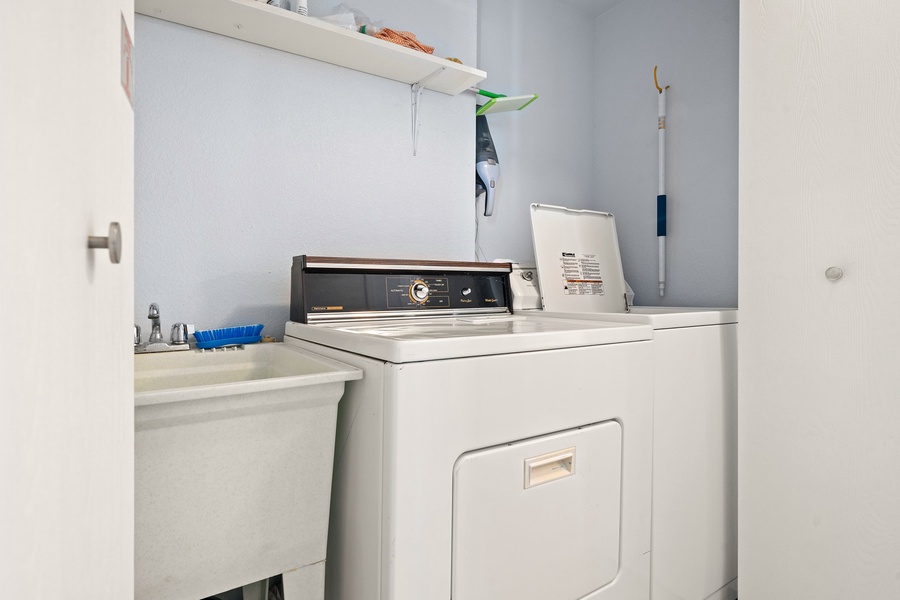 Full laundry room with washer/dryer and sink.