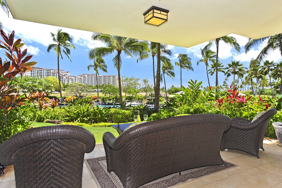 A tropical view on the lanai with elegant patio seating.