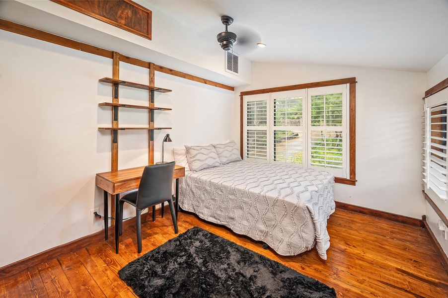 Guest bedroom 7 is also upstairs and has a double bed, ceiling fan, central A/C, garden views, and a workspace