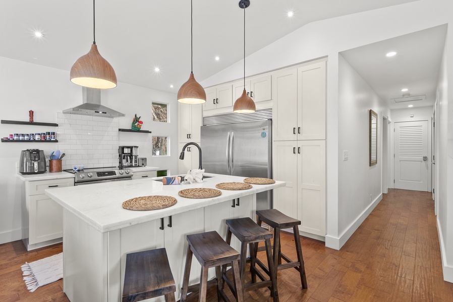 Highlighting the white cabinetry to keep your essentials and the dual door fridge to keep your ingredients fresh.