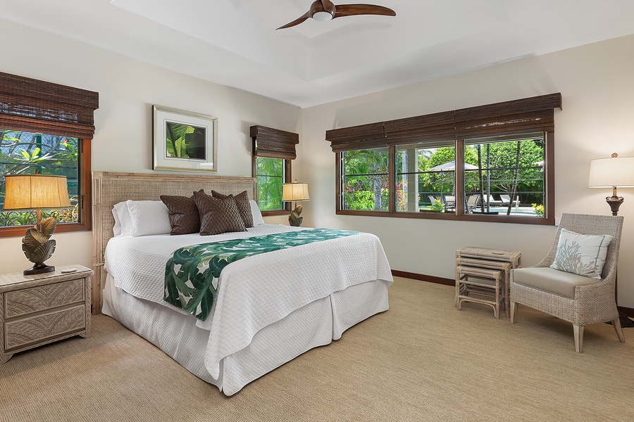 Tennis house guest bedroom featuring a king-size bed, elegant furnishings, and tranquil ambiance.