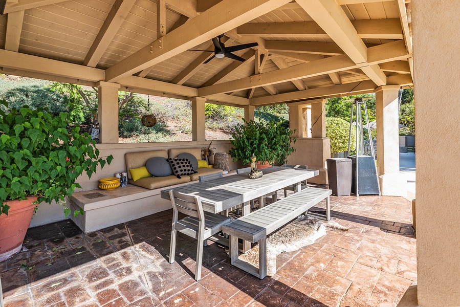 Covered outdoor living/dining room, summer kitchen with bar seating.