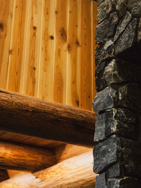 Warm wood accents and stone details create a cozy Scandinavian-inspired atmosphere.