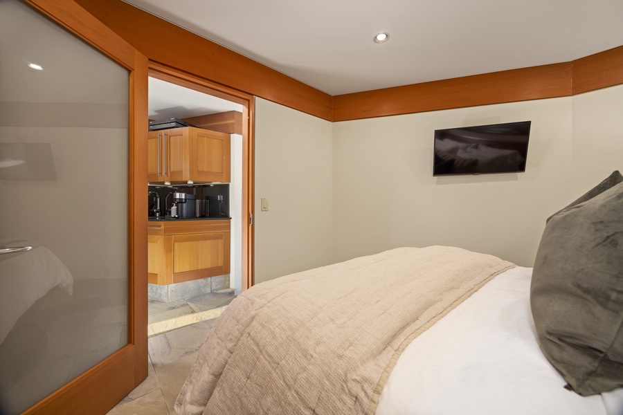 Sink into crisp linens in your private bedroom suite, with a fully equipped kitchen just steps away for midnight snacks.