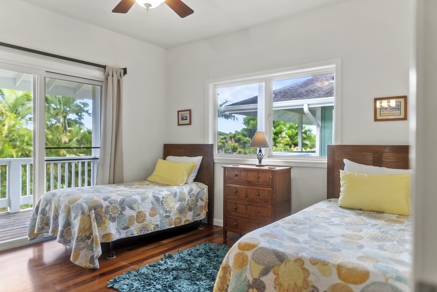 The bedroom offers twin beds, large windows, and calming views of the garden—an ideal setup for families or friends traveling together.
