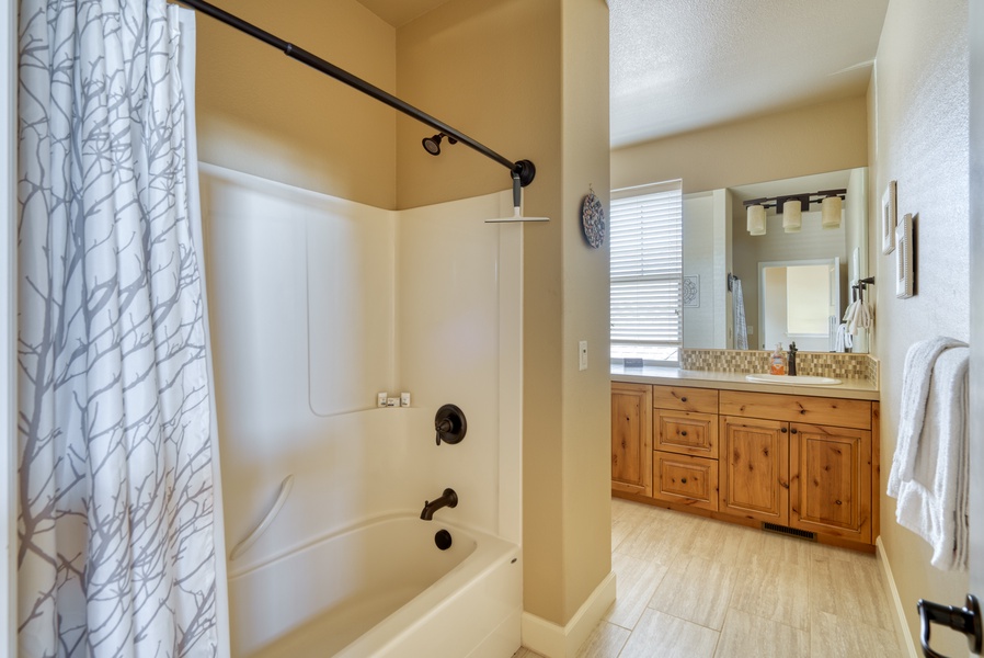 Step into the guest bathroom upstairs and indulge in a refreshing shower, featuring modern fixtures and a sleek design for a revitalizing start or end to your day
