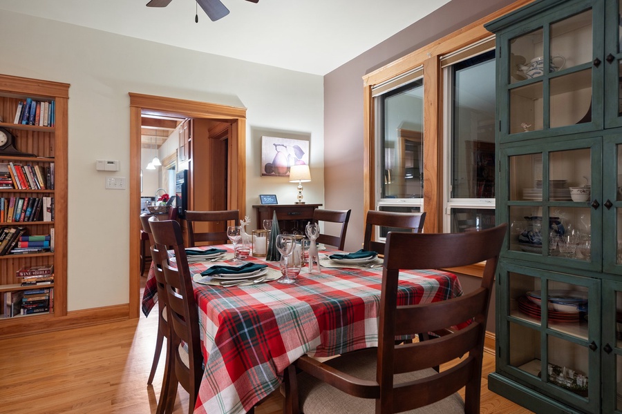 Dining table set with plaid tablecloths and elegant glassware for holiday entertaining.