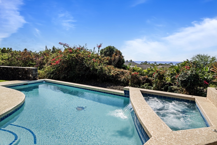 Relaxing poolside area surrounded by lush greenery for a tropical retreat.