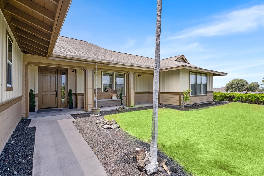 Covered patio opens to a private green space and sunshine.