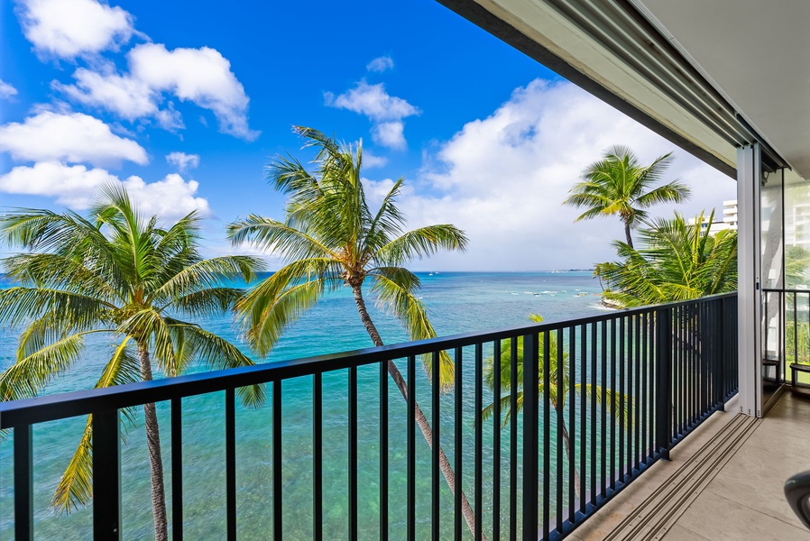 Wake up to vibrant ocean views from your private balcony, surrounded by palm trees and blue skies