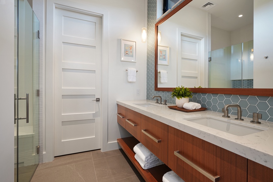 Stylish bathroom with dual sinks and a sleek modern design.