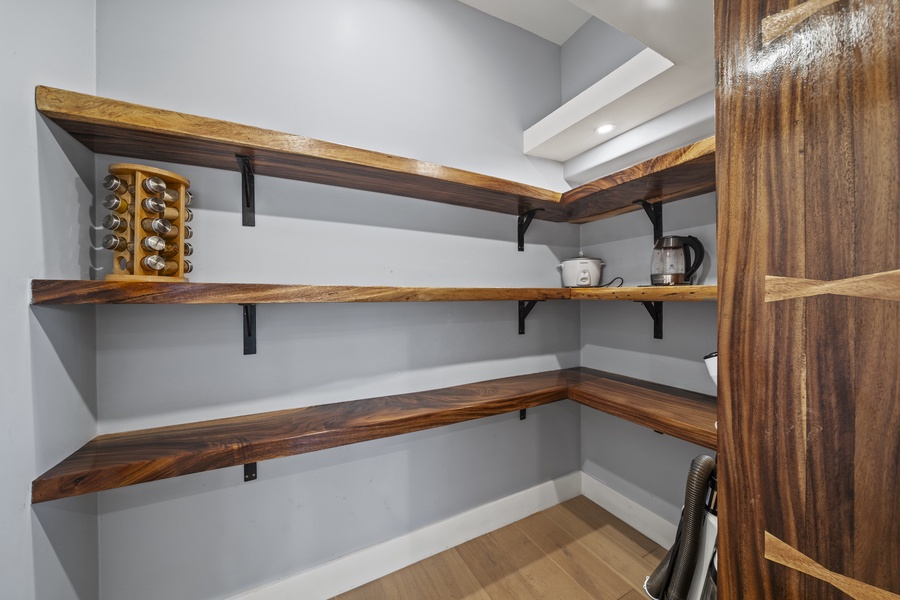 Pantry area with wooden shelves for organized storage.