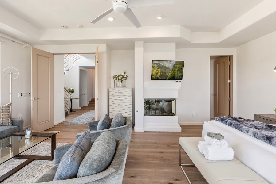 Primary suite with a fireplace and a TV