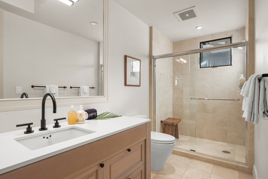 Your spa-inspired bathroom awaits with a sleek walk-in shower, modern fixtures, and premium amenities.