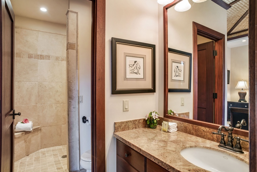 The ensuite bath w/ travertine shower.